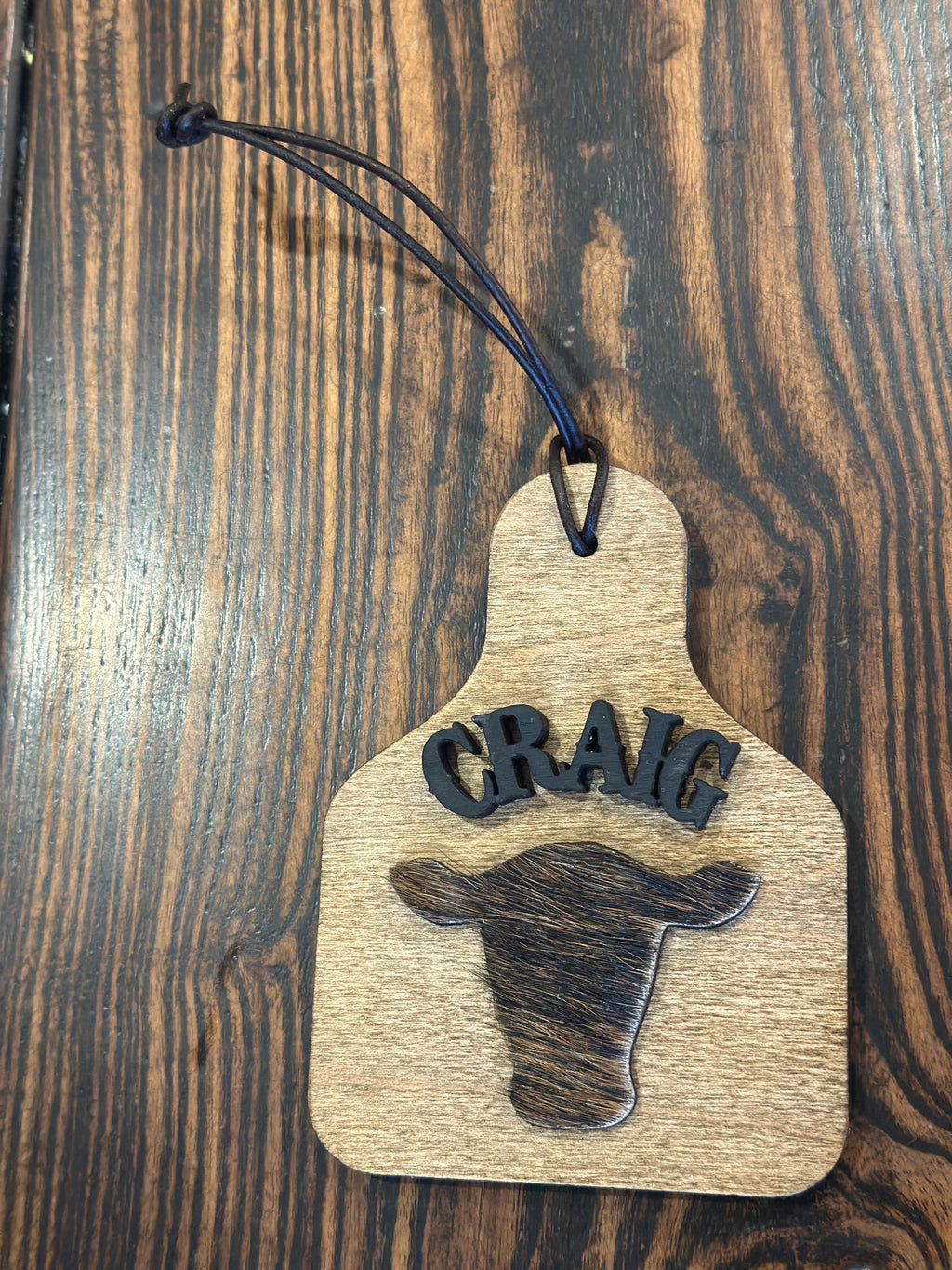 Wood and cowhide cattle tag ornament