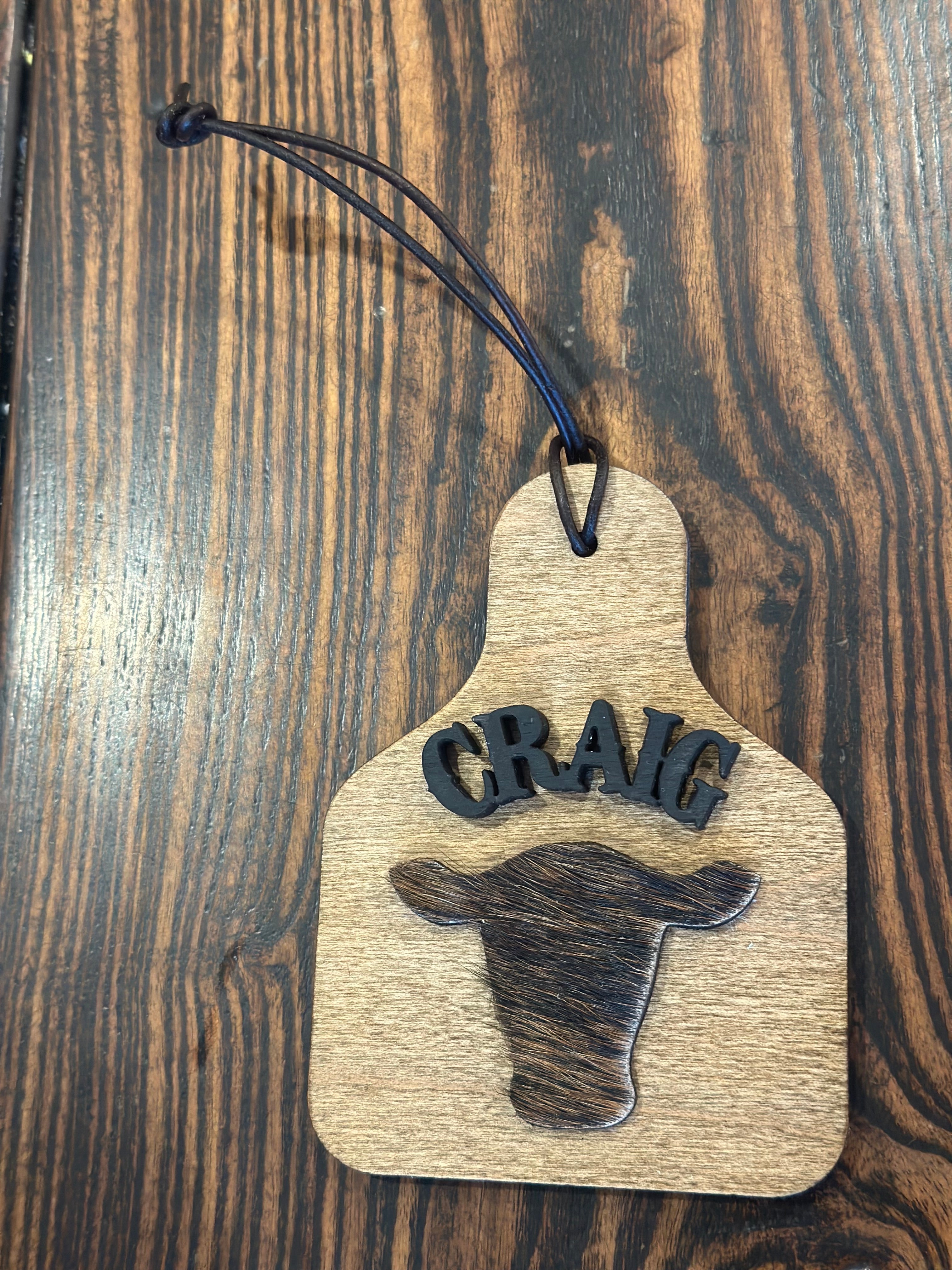 Wood and cowhide cattle tag ornament